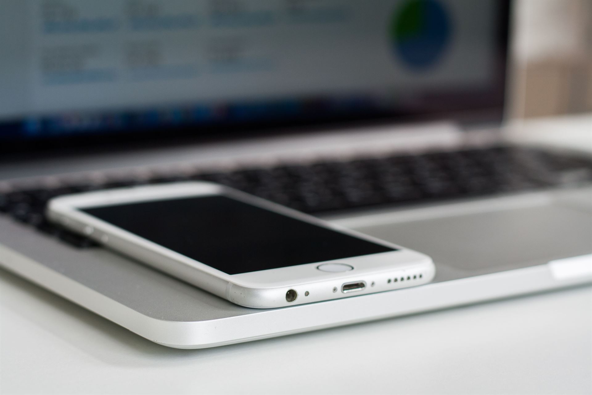Smartphone resting on a laptop, ready for a mobile money transfer