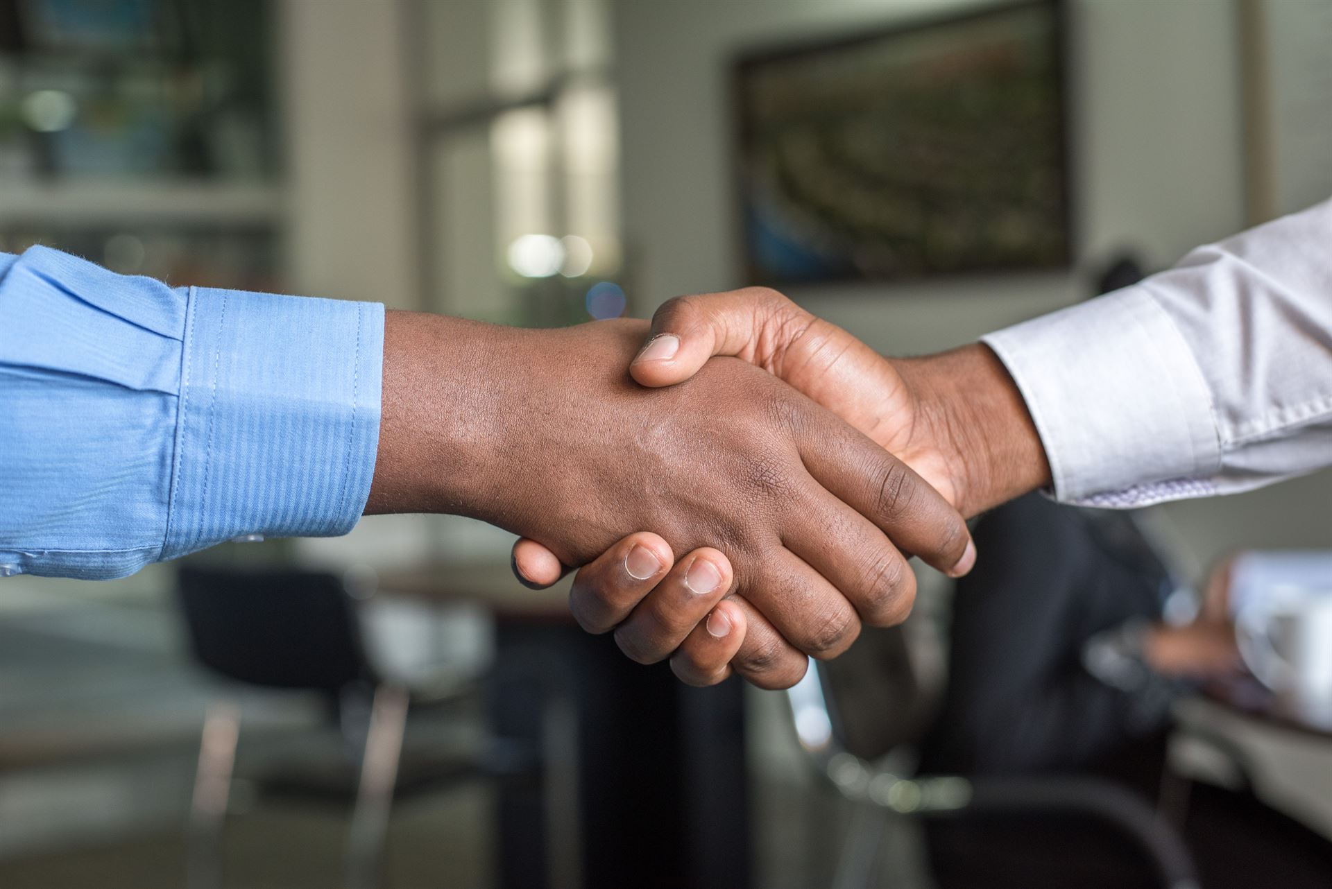 Two people shaking hands in a gesture of trust