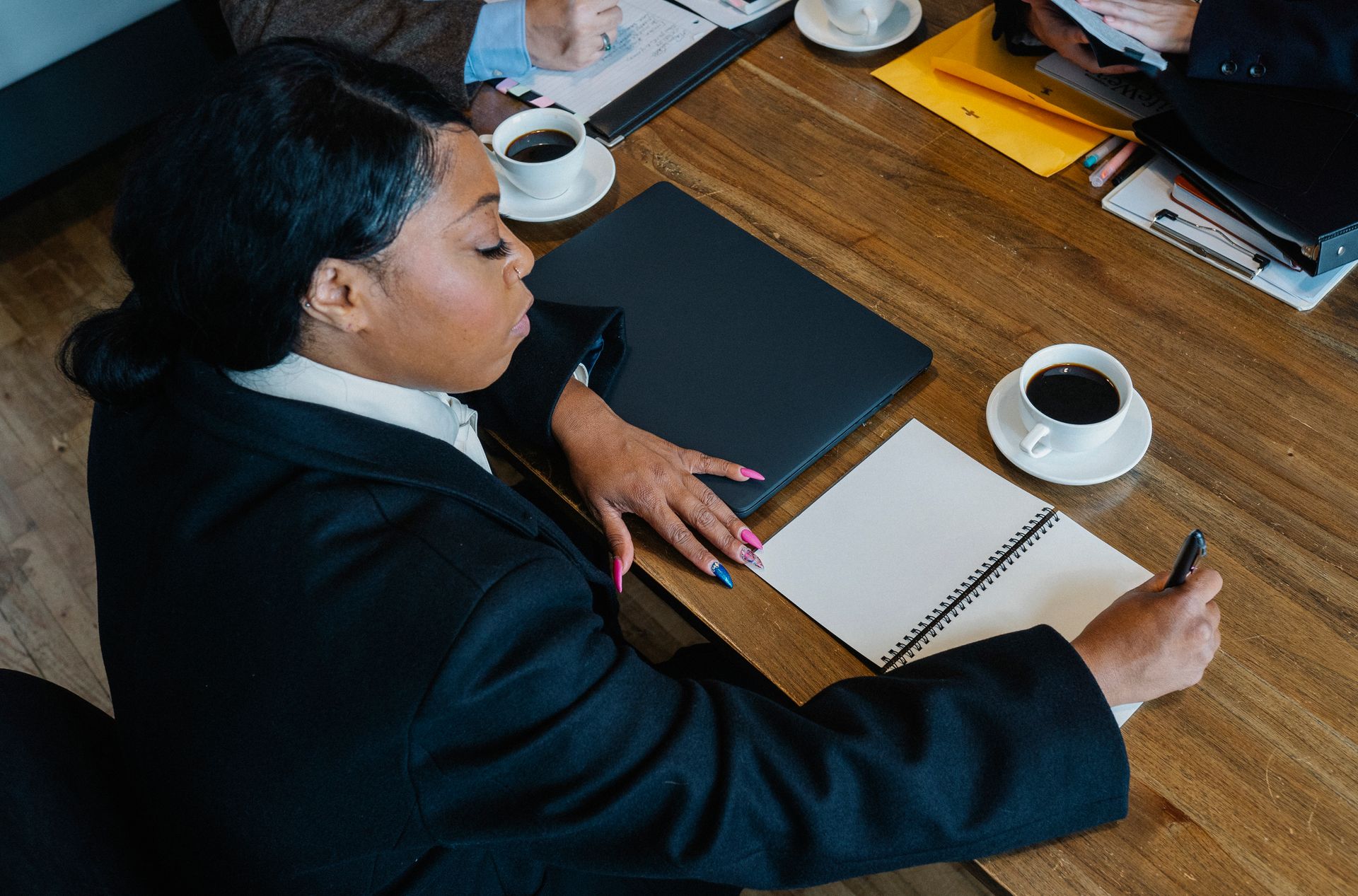Professional taking notes during a business meeting